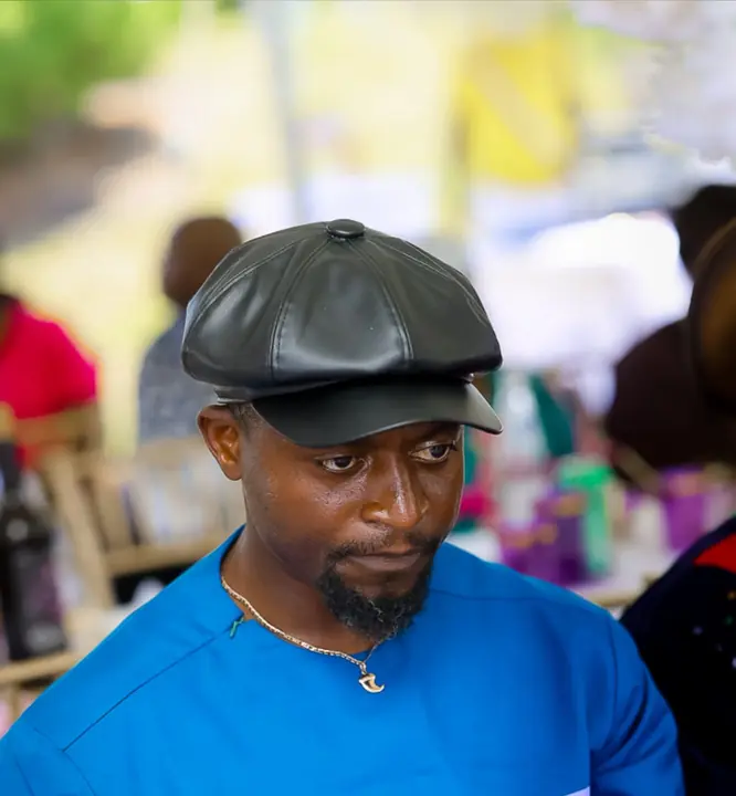 Member in a leather cap and blue outfit
