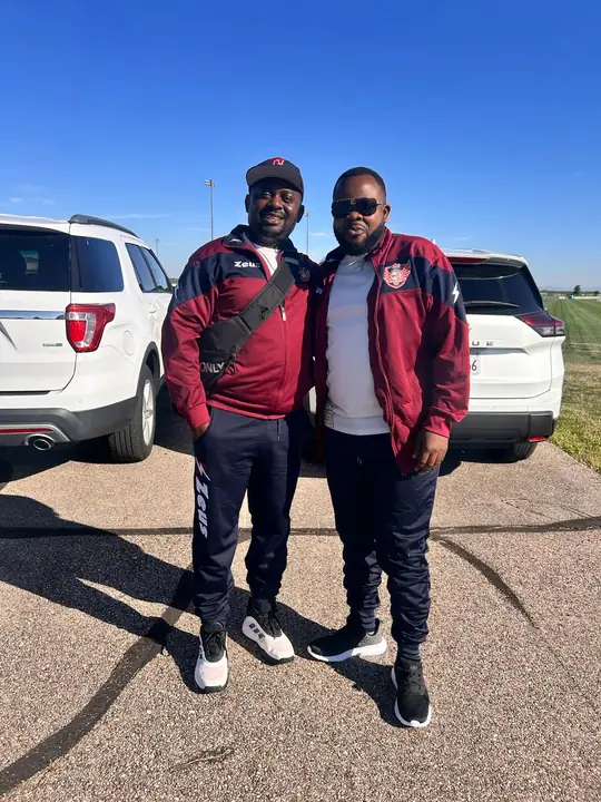 Two CAVFC members in maroon club jackets