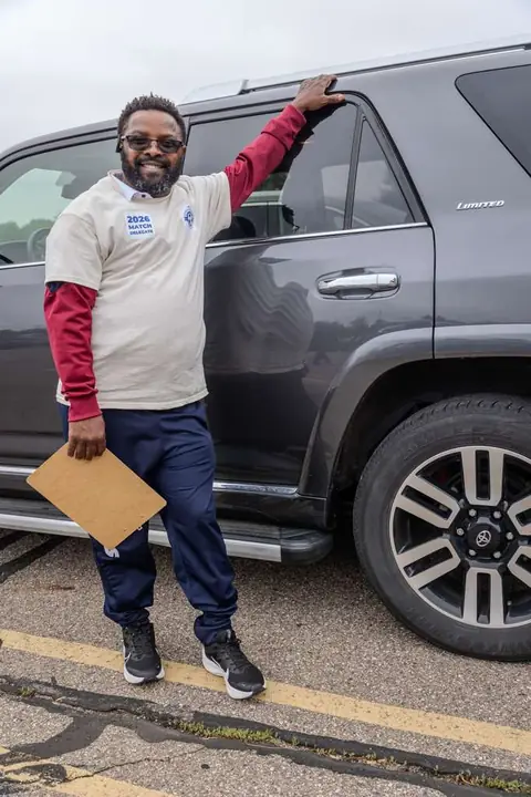 Member in a 2026 match delegate shirt holding a clipboard