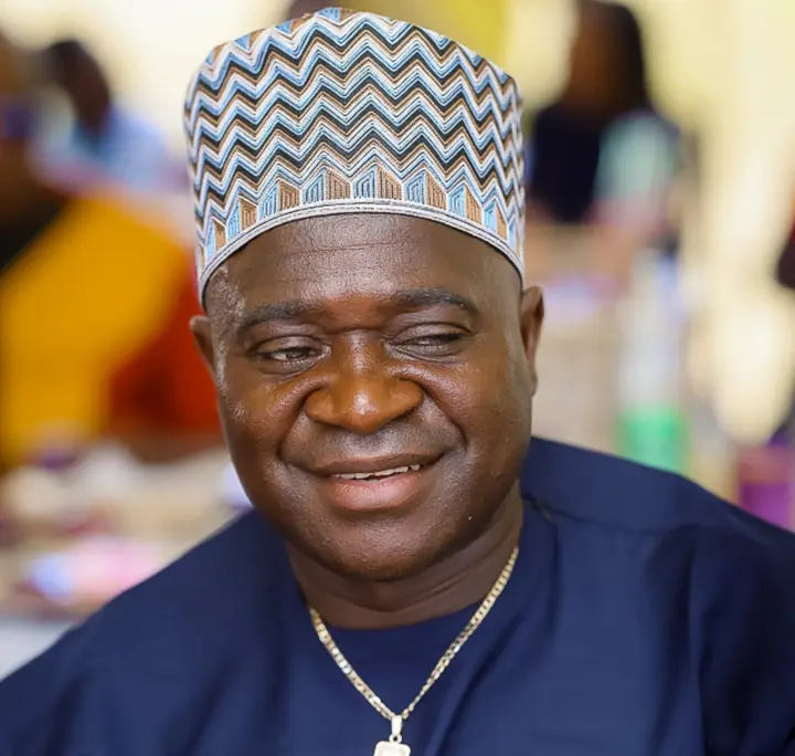 Smiling member in an embroidered cap