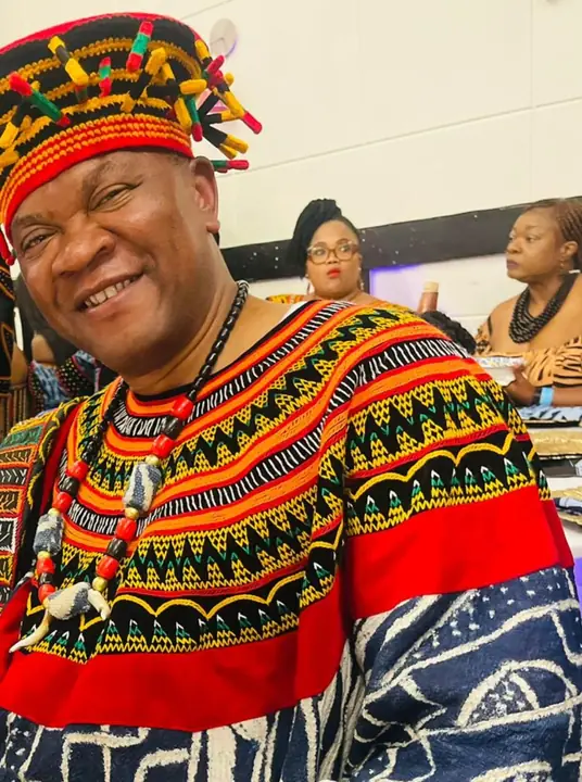 Member in a traditional Cameroonian toghu outfit and headdress